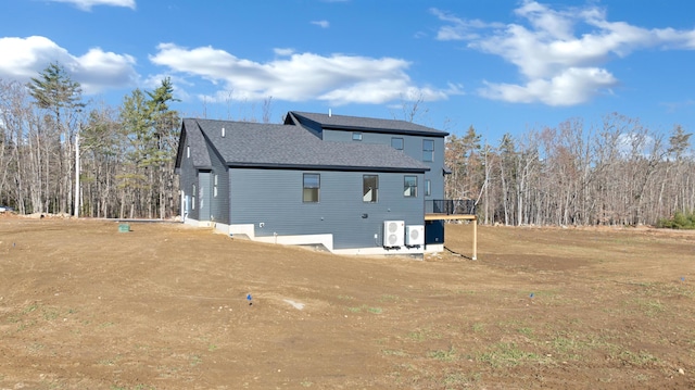 back of house featuring a deck and central AC unit