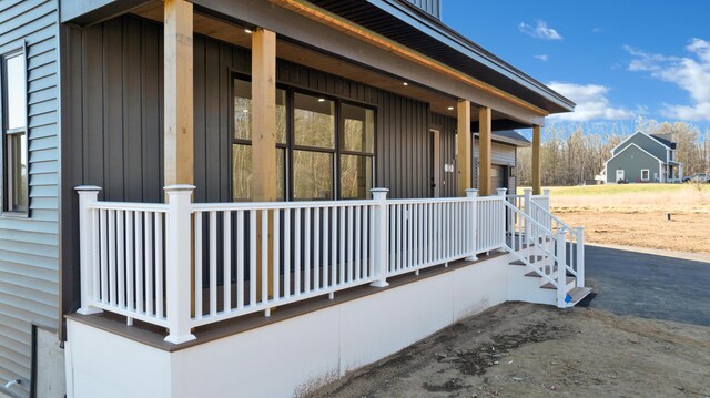 view of side of property featuring a porch