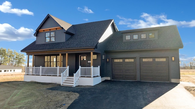 view of front of house featuring a porch and a garage