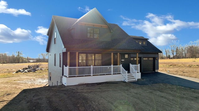 view of front of home featuring covered porch and a garage