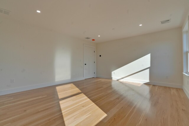 spare room featuring light hardwood / wood-style flooring