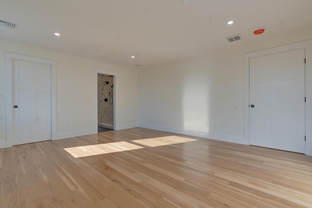 spare room with light hardwood / wood-style flooring