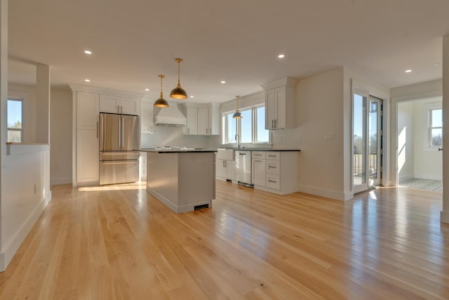 kitchen with plenty of natural light, light hardwood / wood-style floors, and appliances with stainless steel finishes