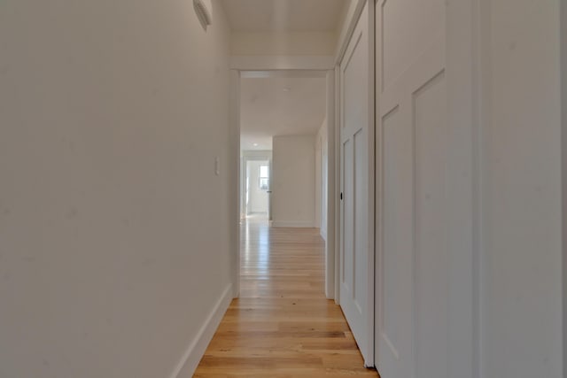 hall with light hardwood / wood-style floors