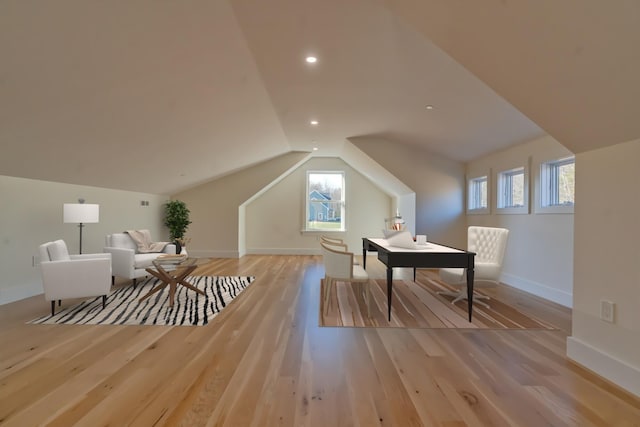 bonus room featuring light hardwood / wood-style floors, vaulted ceiling, and a wealth of natural light