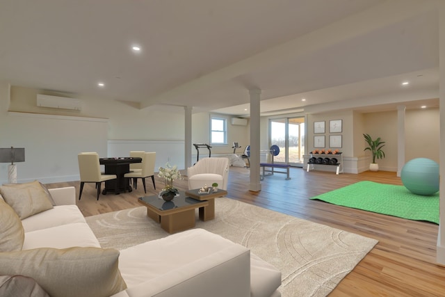 living room featuring a wall unit AC and light hardwood / wood-style flooring