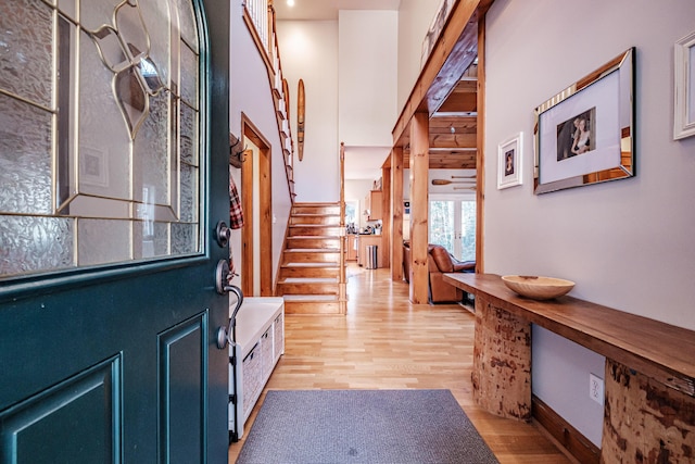 foyer featuring light wood-style flooring and stairs