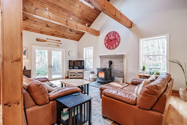 living area with wood finished floors, a wood stove, wood ceiling, french doors, and beamed ceiling