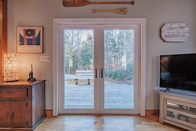 doorway to outside with french doors and light wood finished floors