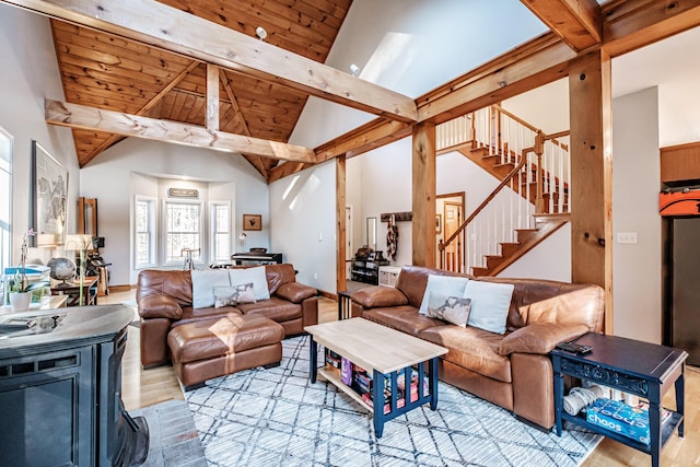 living area featuring stairway, wood finished floors, high vaulted ceiling, wooden ceiling, and beamed ceiling