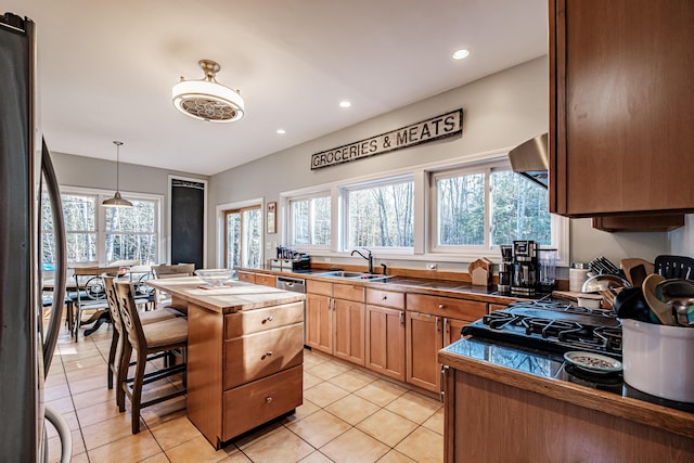 kitchen featuring a sink, a healthy amount of sunlight, recessed lighting, and butcher block counters