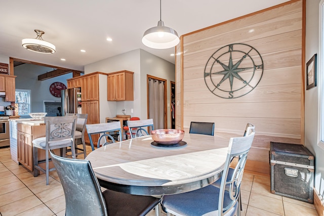 dining space with wooden walls, light tile patterned flooring, and recessed lighting