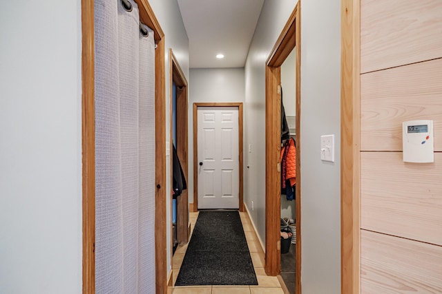 hallway with recessed lighting, baseboards, and light tile patterned flooring