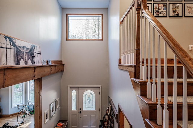 foyer with stairs and baseboards