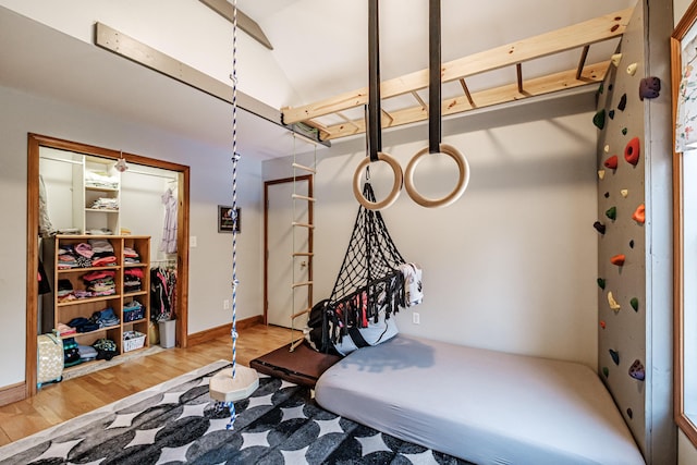 exercise room featuring wood finished floors