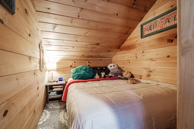 carpeted bedroom with lofted ceiling, wooden ceiling, and wood walls