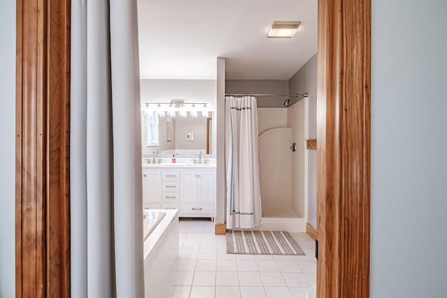 bathroom with tile patterned flooring, double vanity, a shower with curtain, and a sink