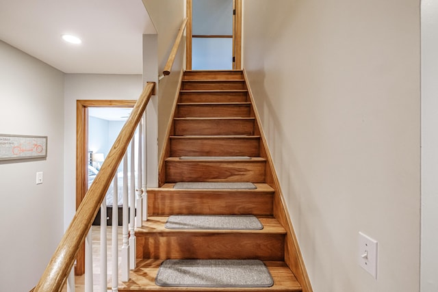 stairs featuring recessed lighting