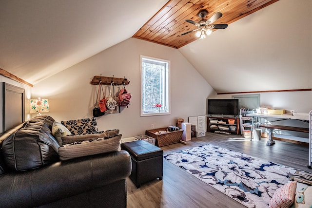 living area with a ceiling fan, lofted ceiling, and wood finished floors