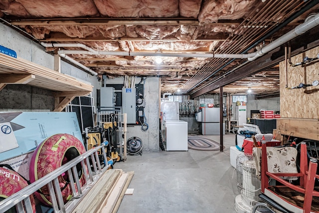 unfinished below grade area featuring refrigerator and freestanding refrigerator