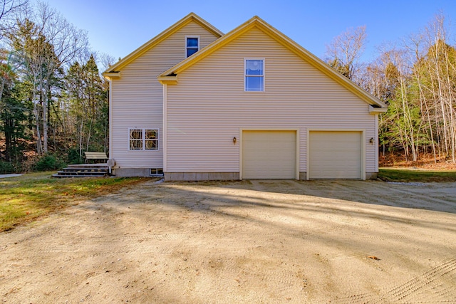 view of home's exterior featuring a garage and driveway