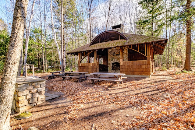 exterior space featuring roof with shingles