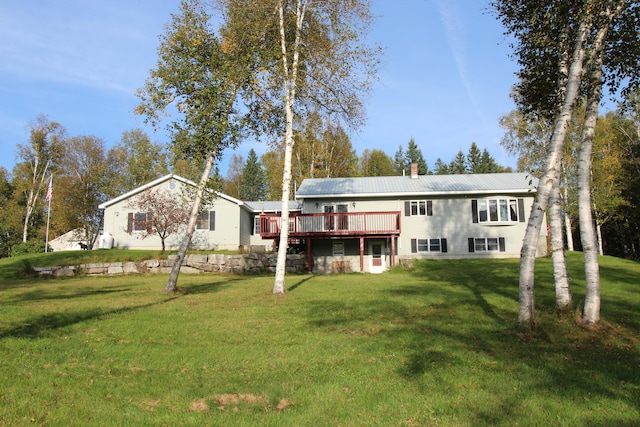 back of house with a wooden deck and a yard