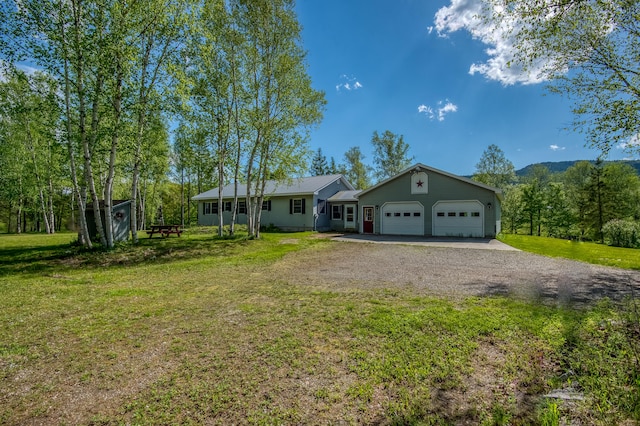 ranch-style house with a garage and a front lawn