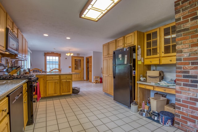 kitchen with kitchen peninsula, a chandelier, decorative light fixtures, light tile patterned floors, and appliances with stainless steel finishes