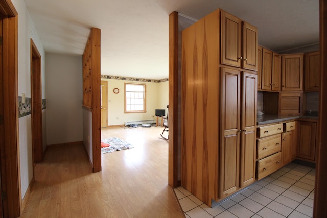 kitchen featuring baseboard heating and light hardwood / wood-style flooring