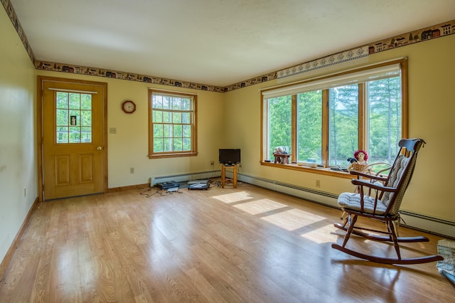 unfurnished room featuring a baseboard radiator and light wood-type flooring