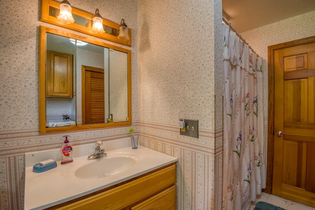 bathroom featuring a shower with shower curtain, vanity, and tile patterned floors