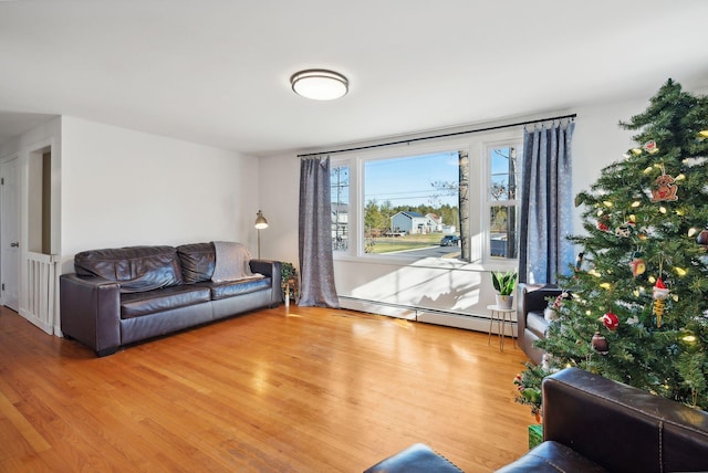 living room with baseboard heating and hardwood / wood-style floors