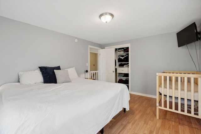 bedroom with a closet and light hardwood / wood-style floors