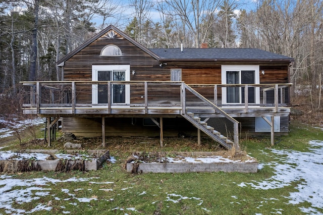 snow covered property with a wooden deck