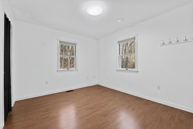 unfurnished room featuring hardwood / wood-style flooring