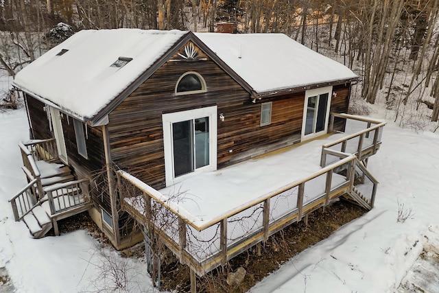 view of snow covered back of property