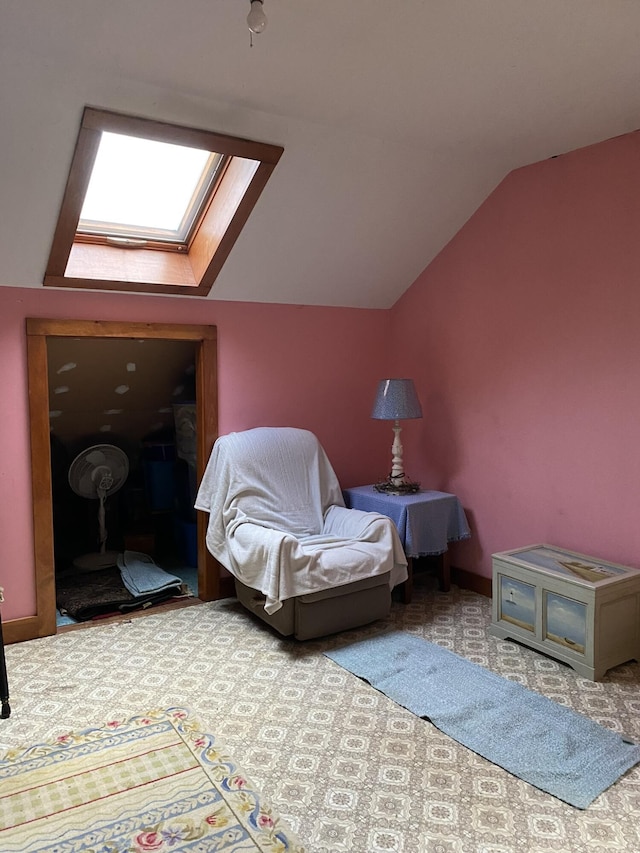 living area with lofted ceiling with skylight and carpet floors