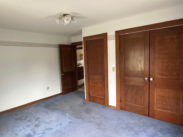 unfurnished bedroom featuring dark carpet