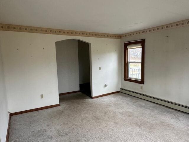 carpeted empty room with a baseboard radiator