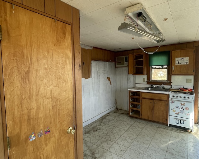 208 Depot St, Union, ME 04862 - kitchen featuring brown cabinets, wood walls, light countertops, dishwasher, and a sink