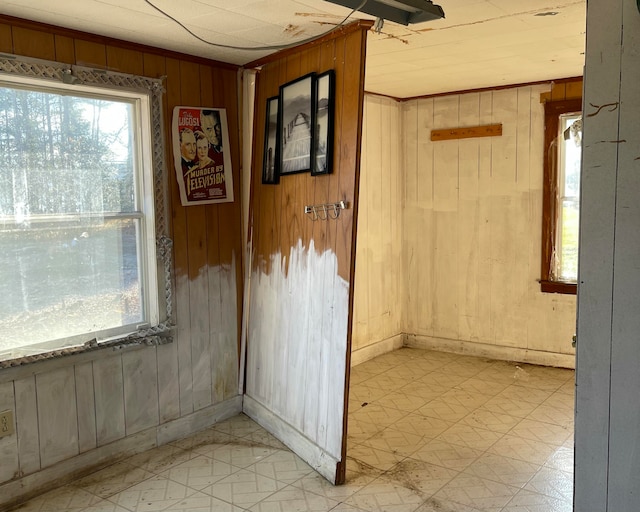 tiled spare room with wood walls