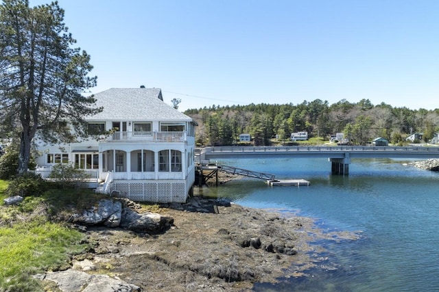 dock area featuring a water view and a balcony