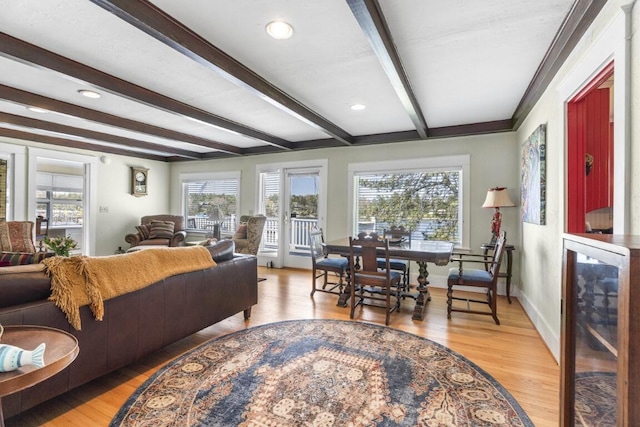 living room with beam ceiling and light wood-type flooring