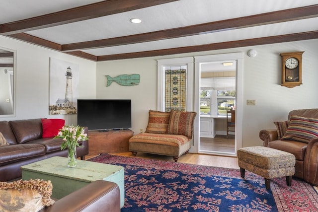 living room with beamed ceiling and light hardwood / wood-style floors