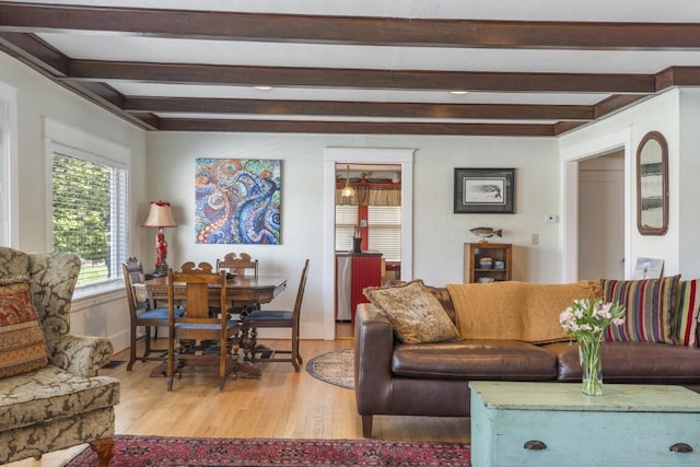 living room featuring beamed ceiling and wood-type flooring