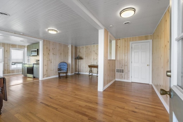 foyer with wood walls and wood-type flooring