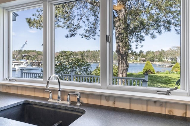 interior details with sink and a water view