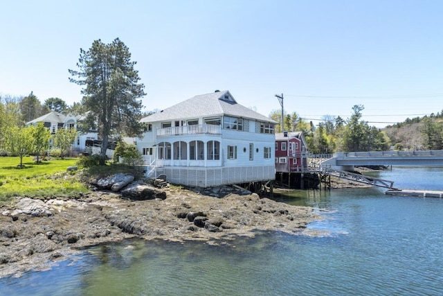 rear view of property with a water view