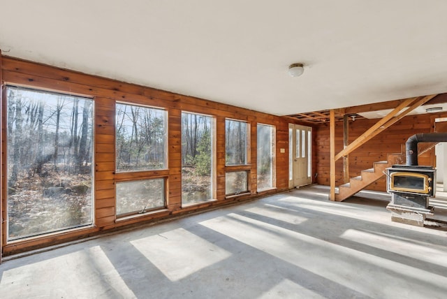 unfurnished sunroom with a wood stove